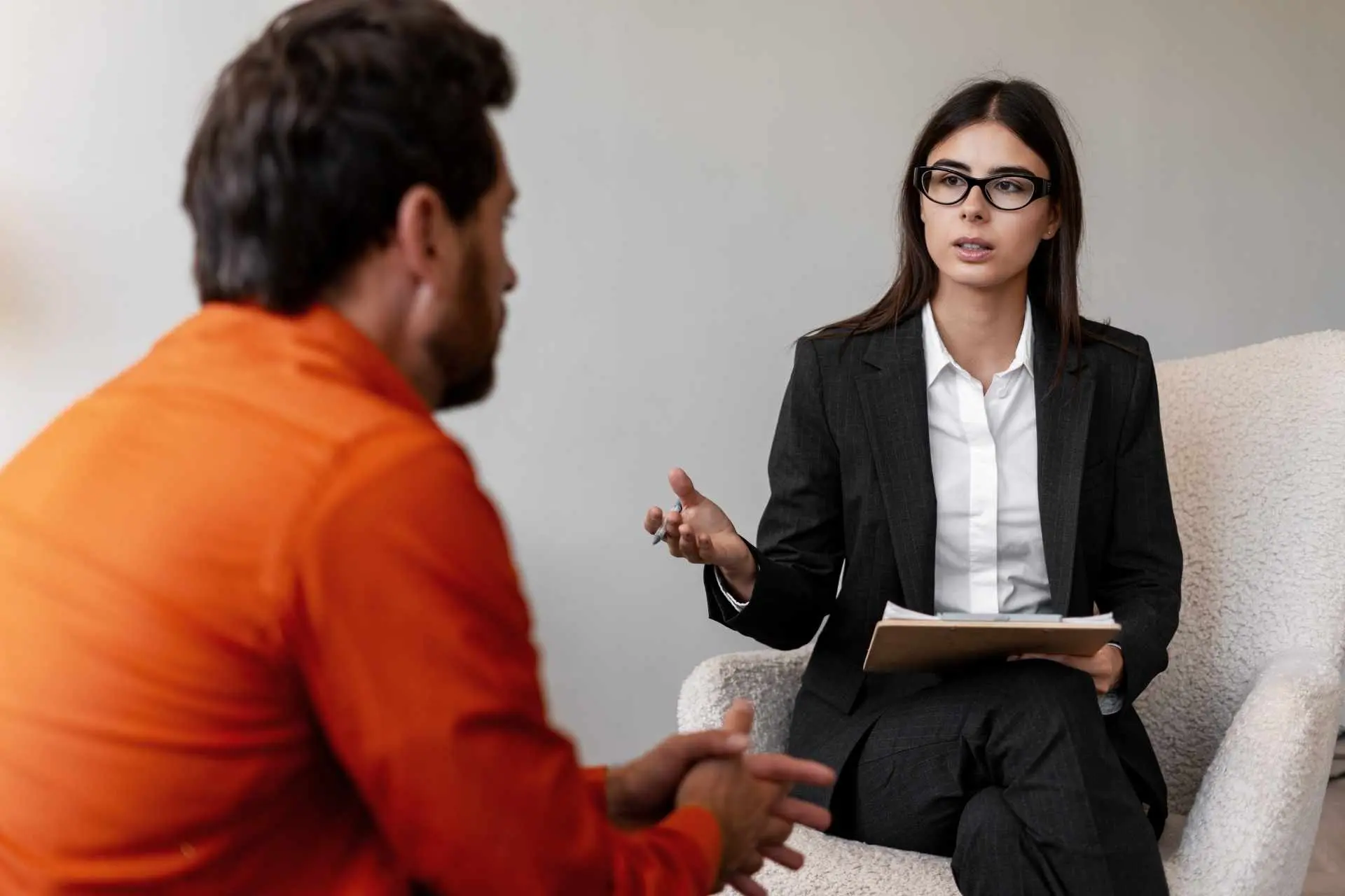 Therapist speaking with a patient during a mental health treatment session